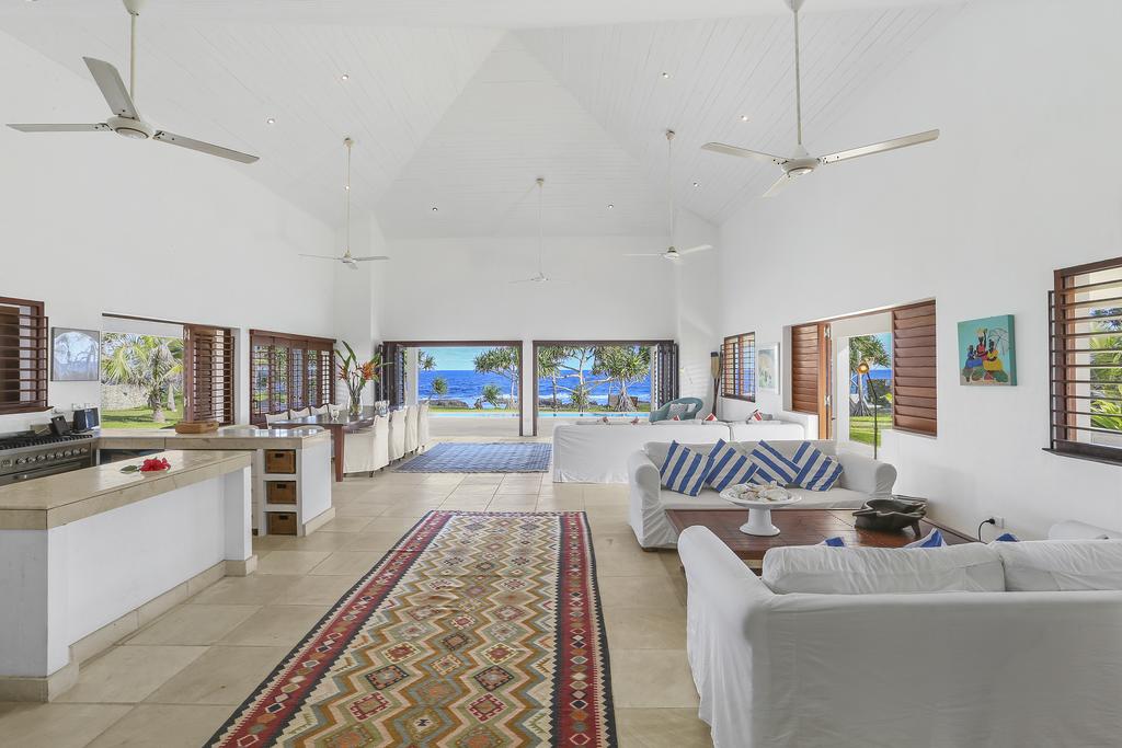 Spacious living area opening to the pool and beach